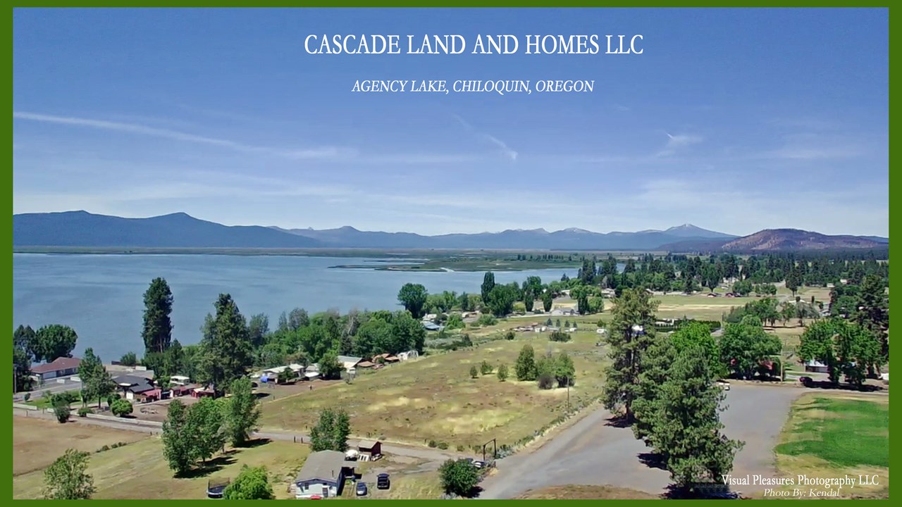 drone view of agency lake showing the subdivisions on the east side of the lake. the cascade mountains and foothills offer a spectacular backdrop.