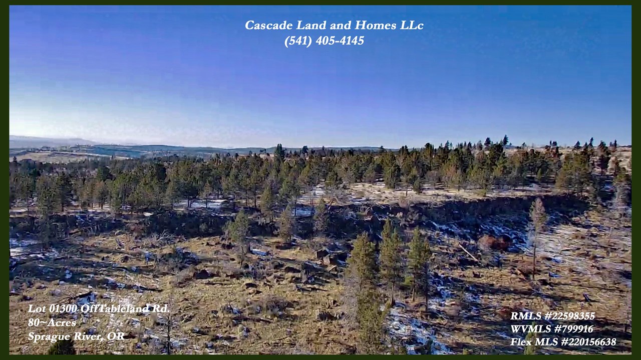 this is a drone view from above the property looking southwest. there are many rocky outcroppings and interesting rock formations on the property and the surrounding wilderness.