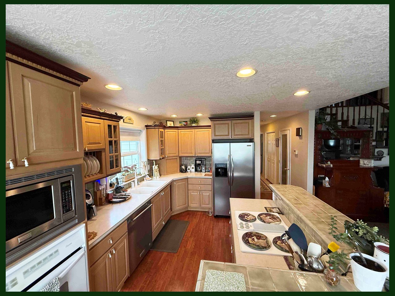 large custom kitchen open to living and dining room- perfect for entertaining