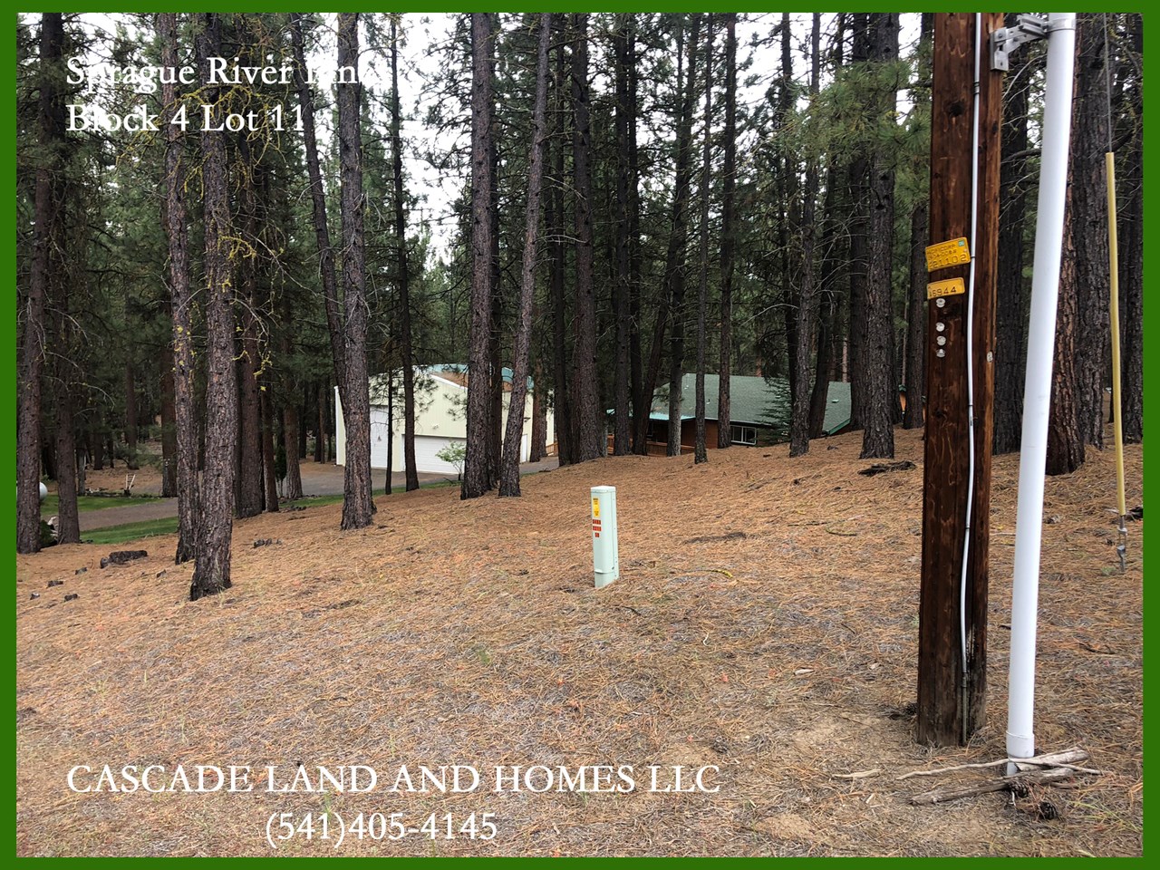 power is at the corner of the property. the home in the background of this photo is the adjacent property owner. we met them while we were there. the people here are friendly and live a quiet lifestyle in the tranquility of the forest.